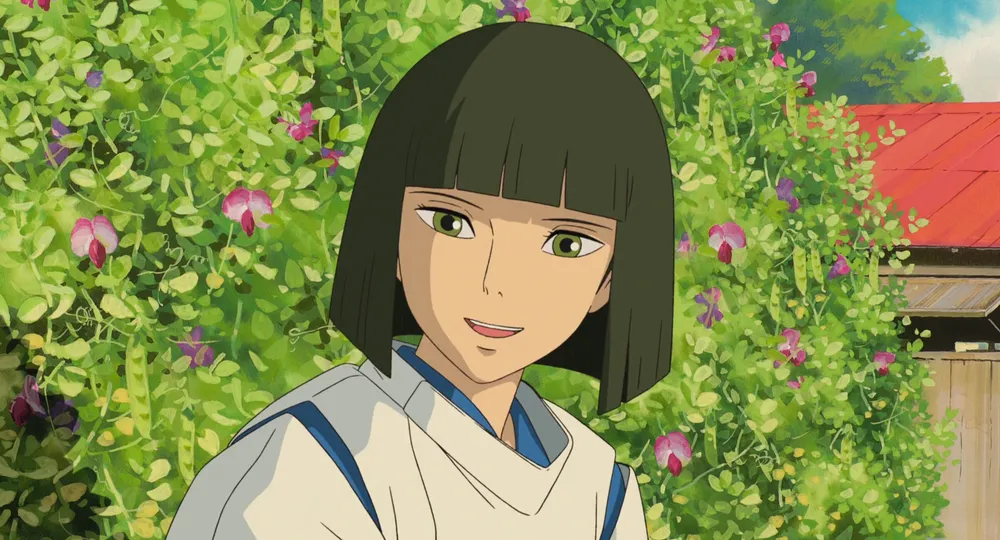 A gentle close-up of Haku from Spirited Away, a young boy with dark green hair and a kind expression, set against a vibrant background of green foliage and pink flowers, evoking a sense of tranquility and warmth.